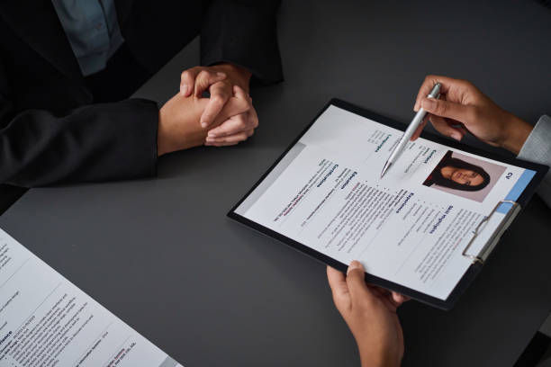 High angle view of specialist asking questions to applicant at meeting High angle view of specialist asking questions to applicant at meeting