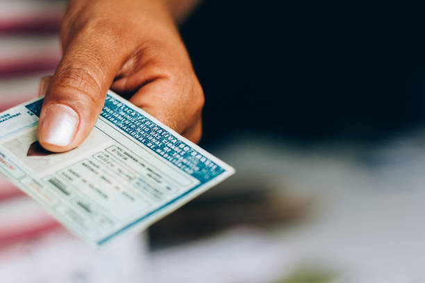 d1 Man holds National Driver's License (CNH). Official document of Brazil, which attests the ability of a citizen to drive land vehicles.