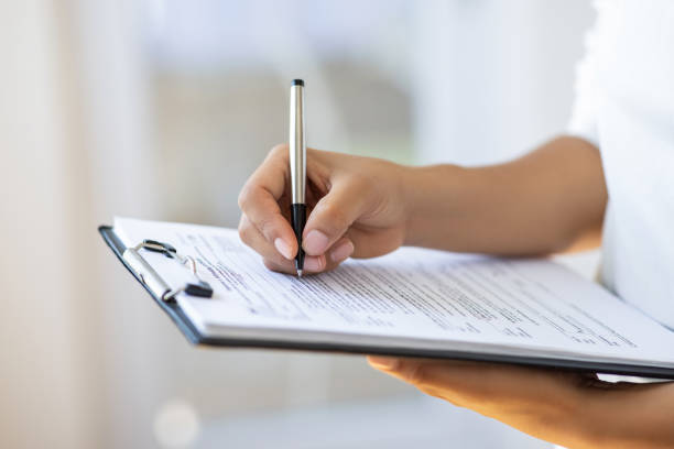 Holding clipboard and a pen in office Holding clipboard and a pen in office